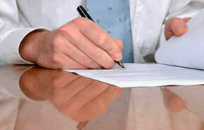 apply Person is writing something on the paper