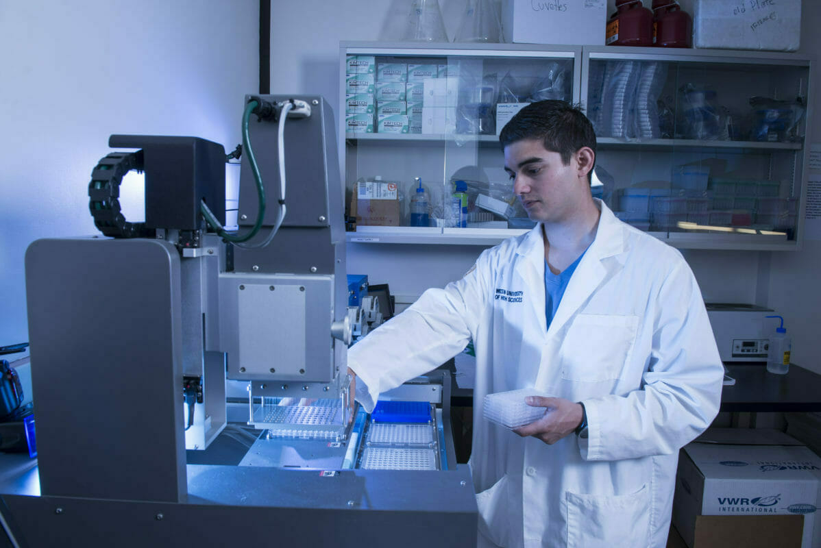 URC lab Swairjo Manal Swairjo, PhD, Assistant Professor, Graduate College of Biomedical Sciences at Western University of Health Sciences poses oe works with a crystilzation robot in her lab with research assistant Jonathan Alvare