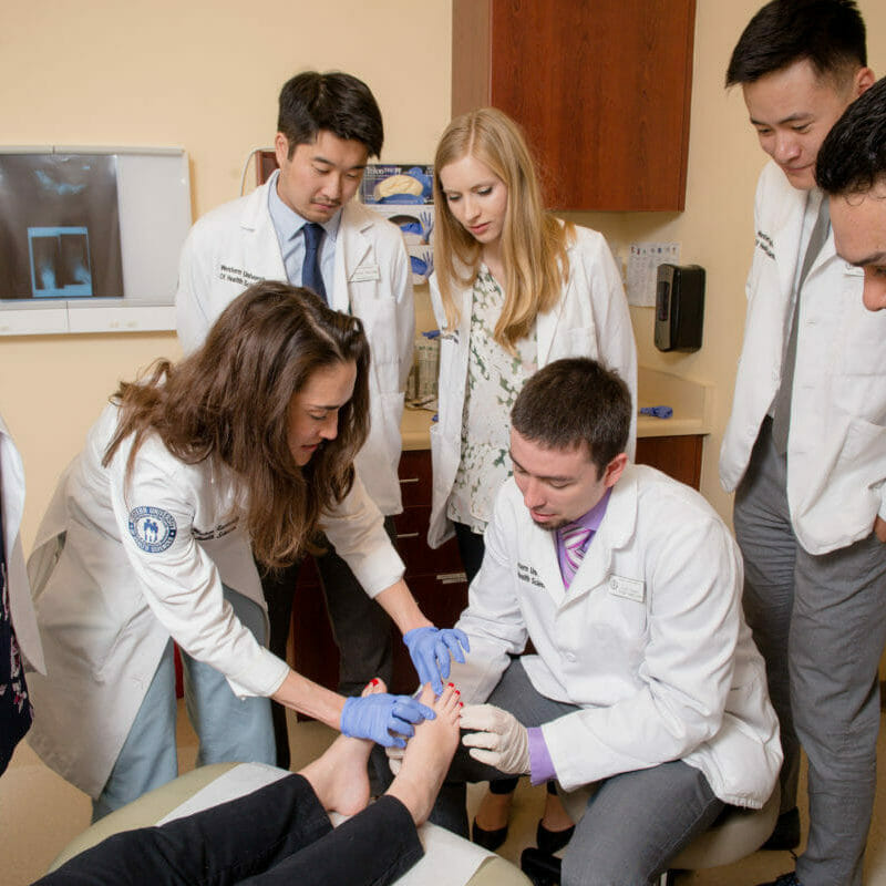 Physician portray a foot exam and a gait analysis at the Foot & Ankle Center in the Patient Care Center.