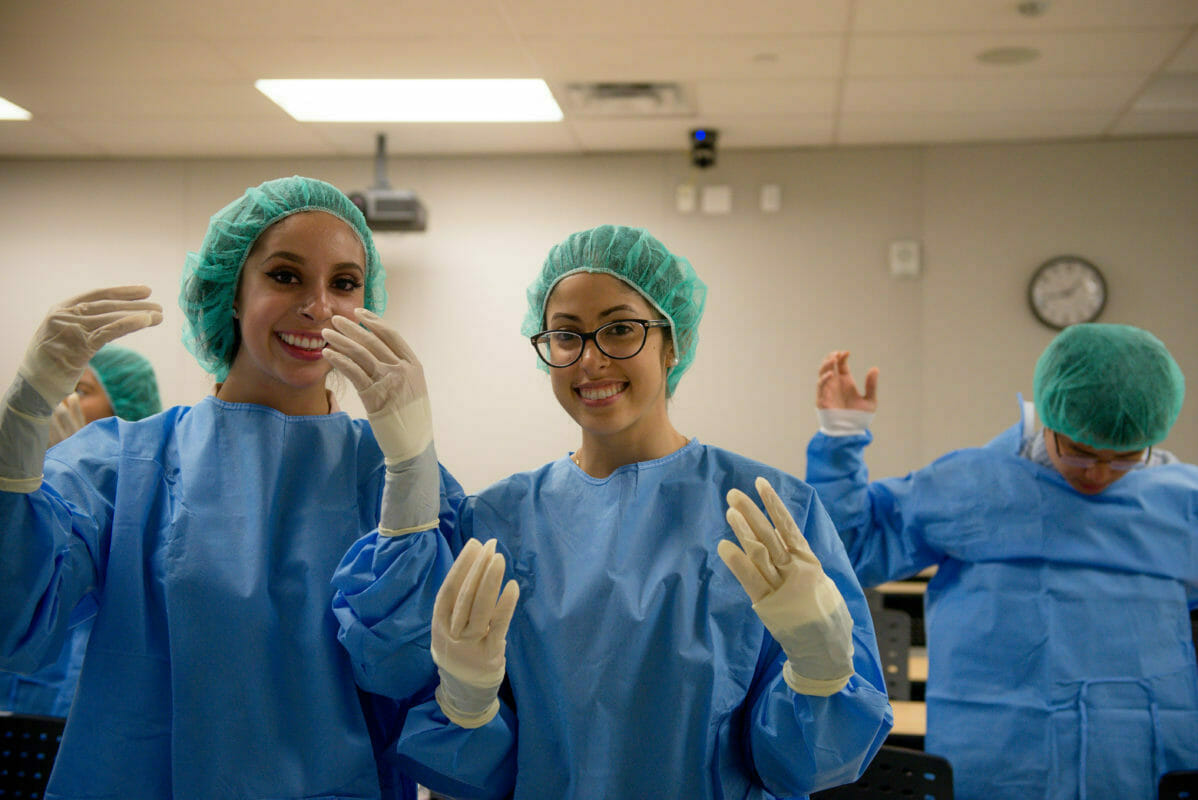 WesternU SHPEP students participated in a podiatry rotation getting hands-on experience putting on scrubs and practicing suturing on a banana. College of Podiatric Medicine